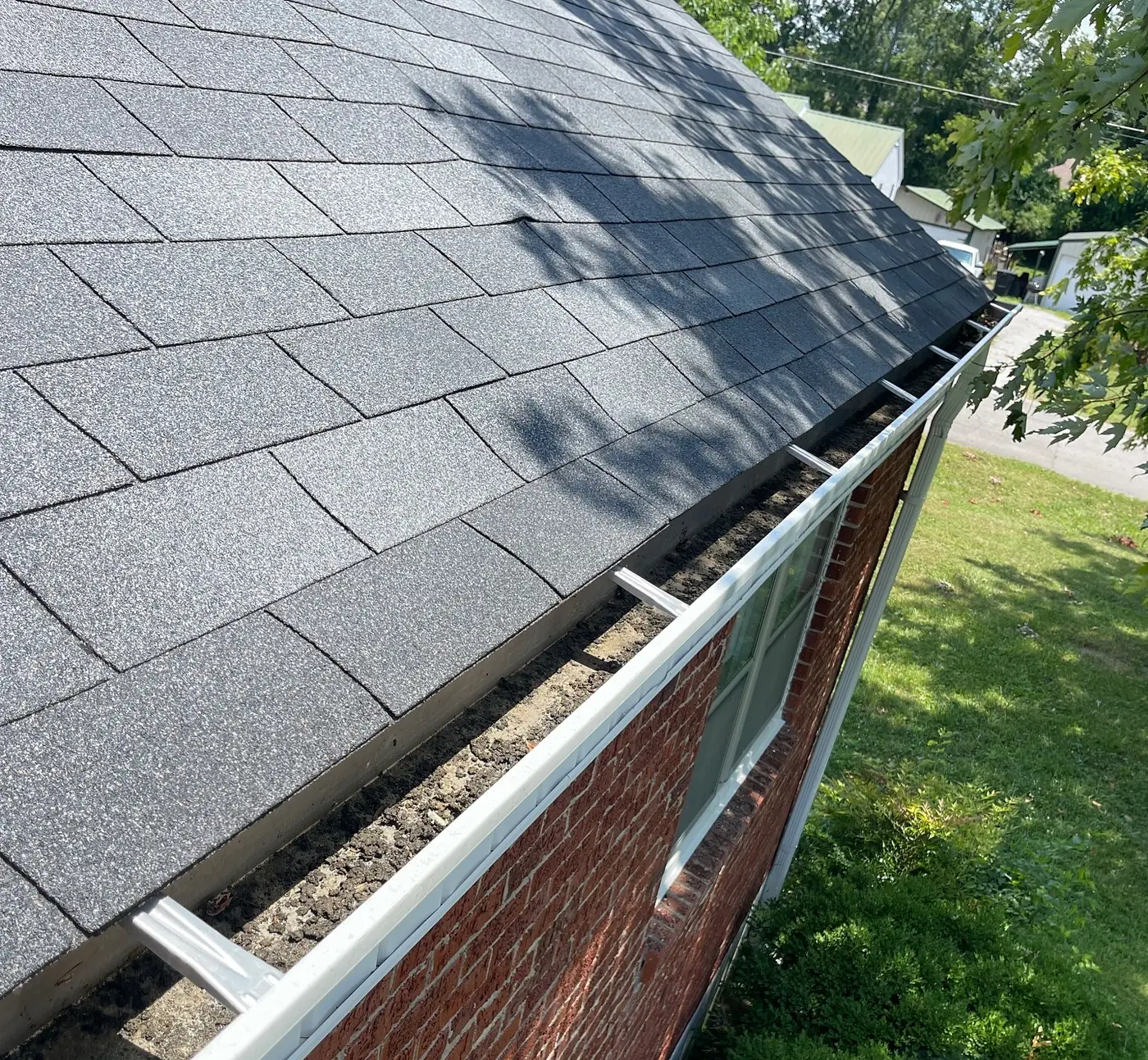 Clogged Gutter Full of Debris Before Cleaning (before)