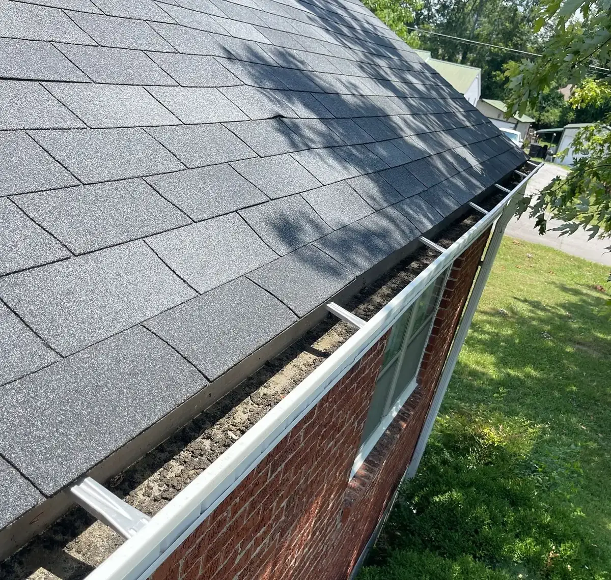 Gutter packed with debris, before