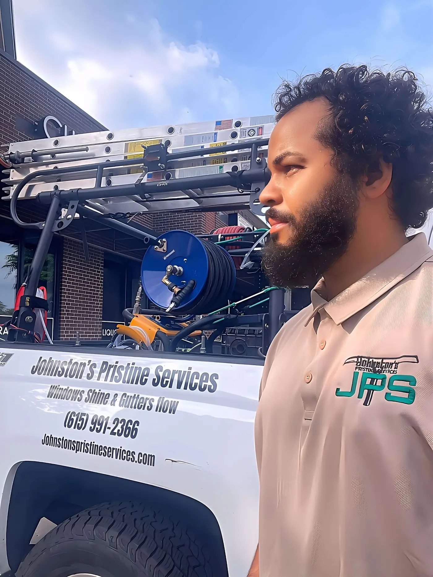 Hasan Johnston standing beside the Johnston's Pristine Services truck