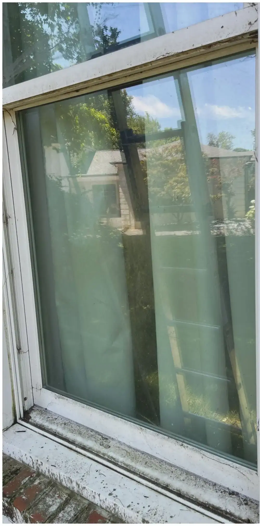 Window with water spots and haze before cleaning